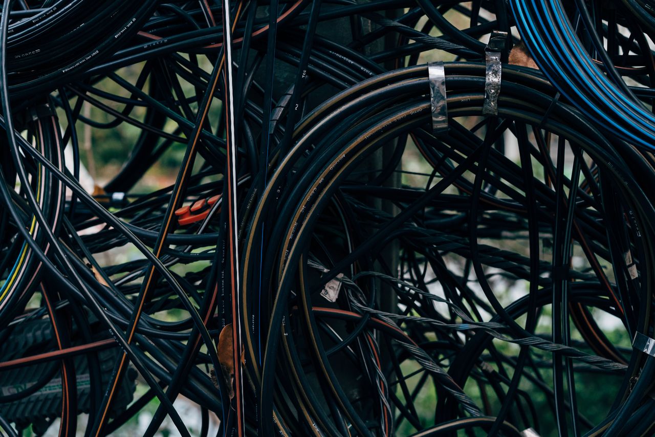 heros-img Close-up view of a complex tangle of electrical wires outdoors.